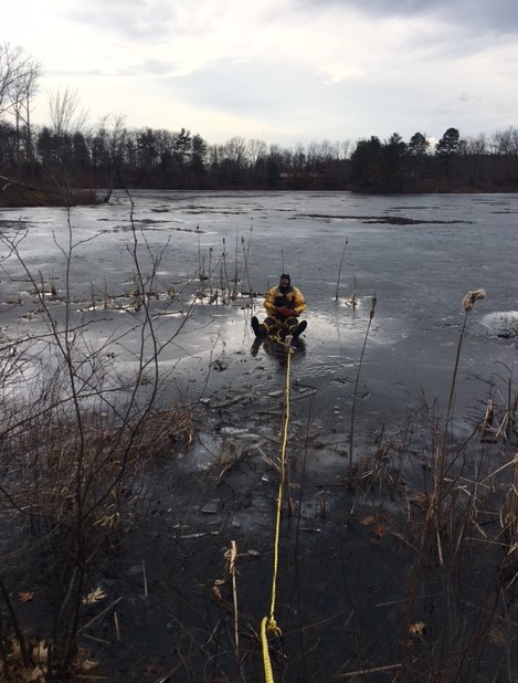 Capt. Johnston rescues a dog from the ice on Grove Pond